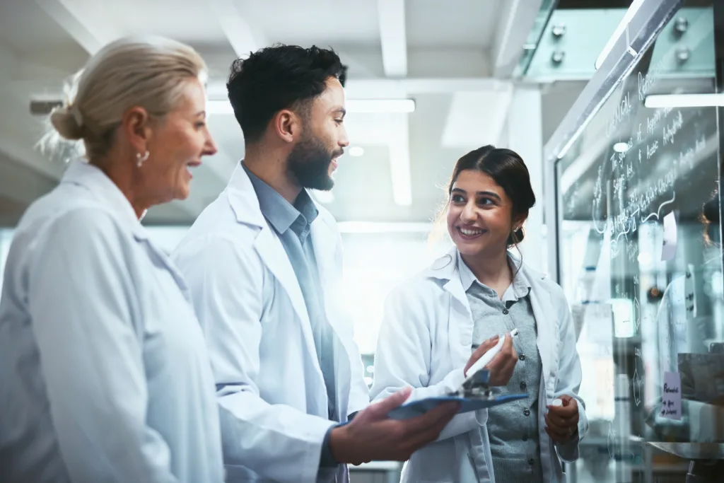 Medical professionals brainstorming on a whiteboard