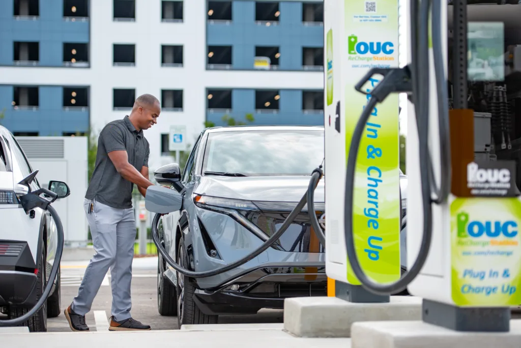 Man charging car at OUC charging station