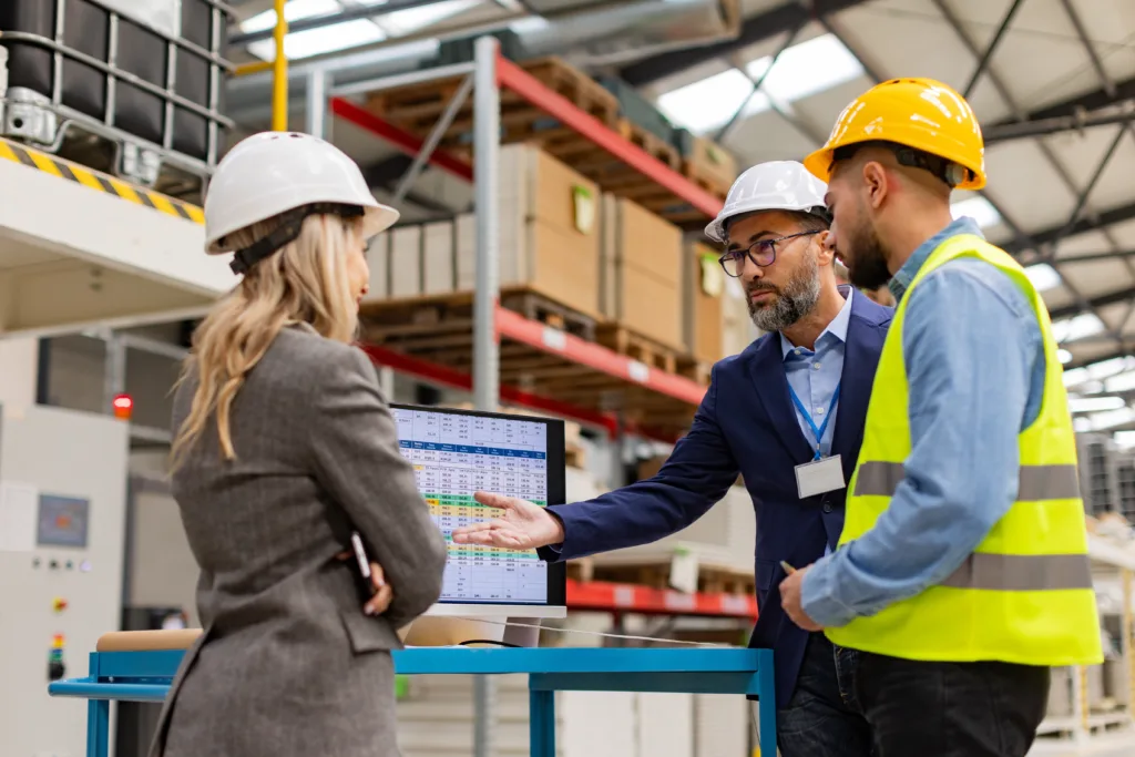 Three businesspeople in a factory