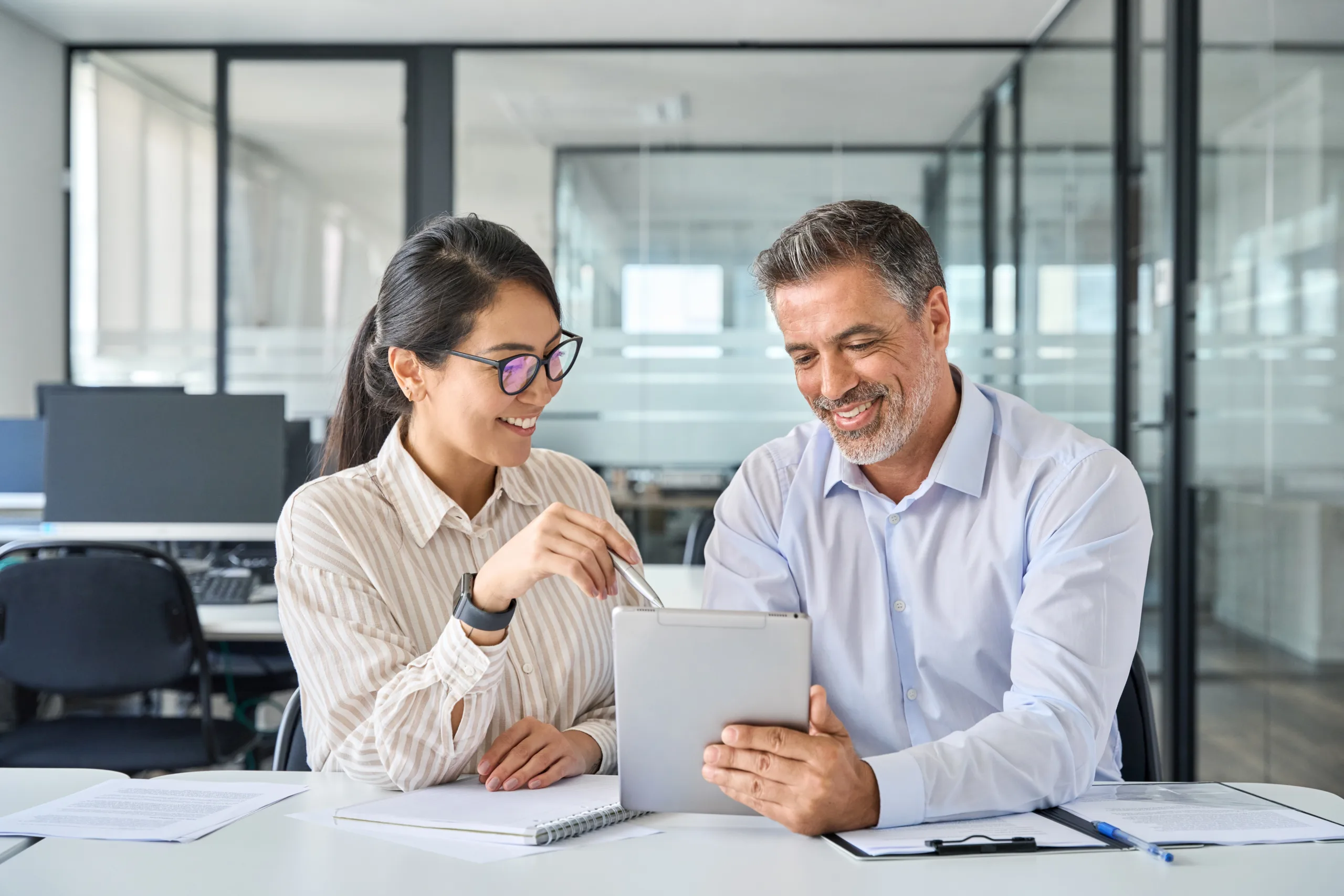 Man and woman reviewing a report in an office