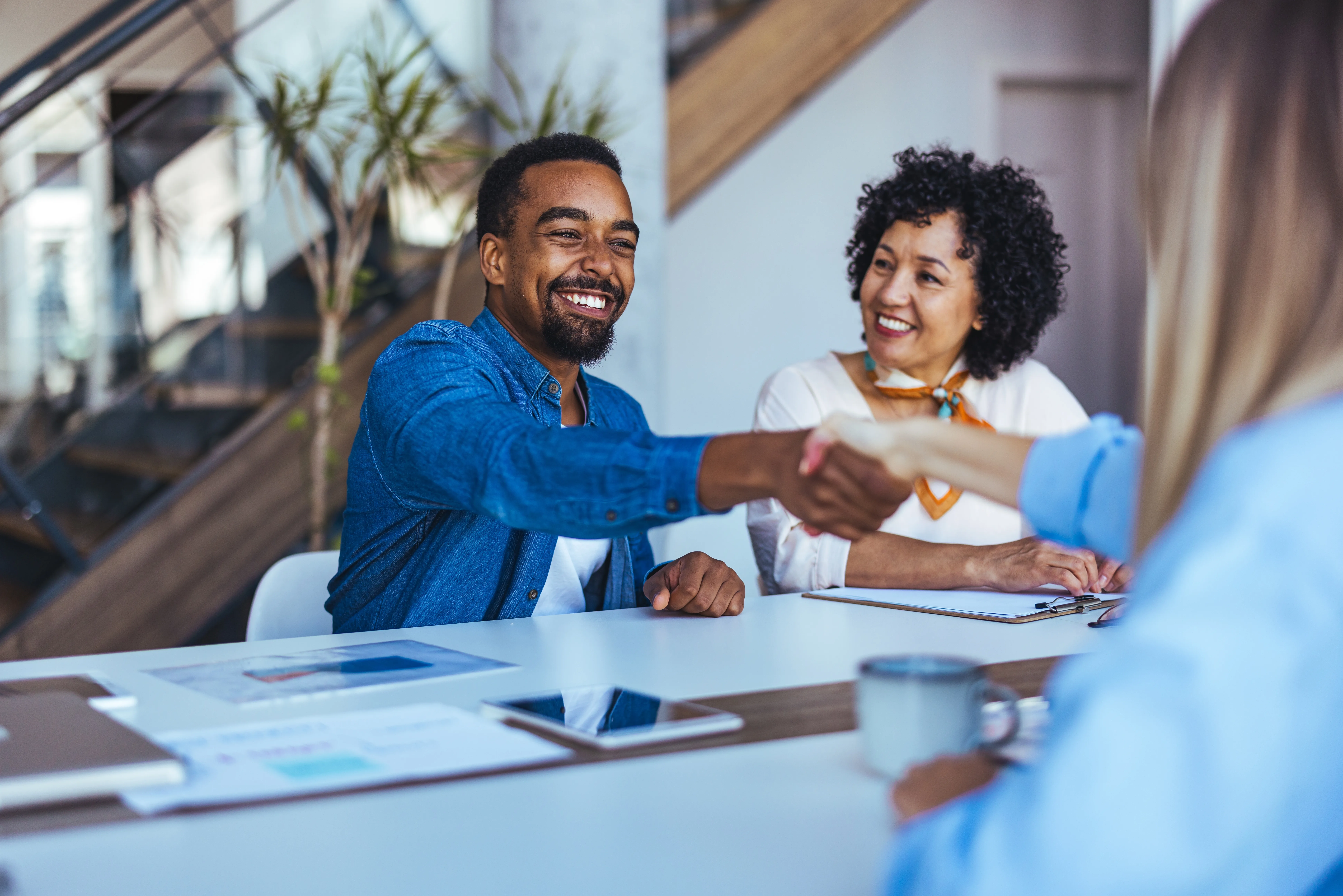 People shaking hands at an office desk